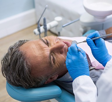 Dentist examining patient's teeth