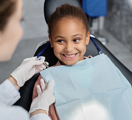 Child smiling in the treatment chair