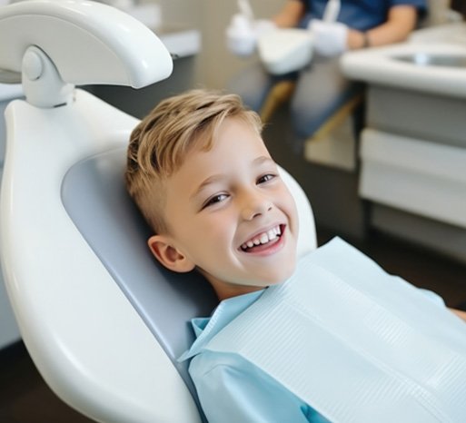 Smiling young boy in dental treatment chair