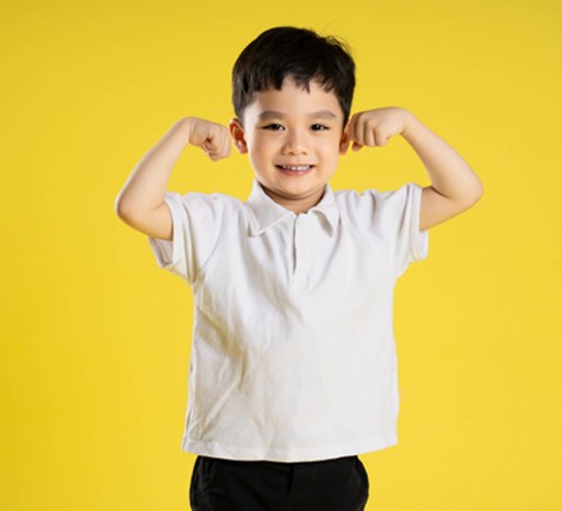 Small boy posing against yellow background