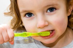 Young girl brushing her teeth